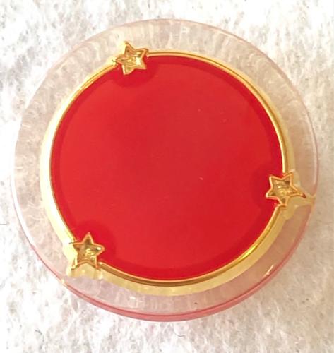 Bouton plastique rouge et or avec contour transparent